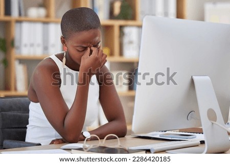 Headache, migraine and sad woman on computer stress, depression or mental health risk in office for news. Pain, depressed or angry African business person with burnout or fatigue for online career