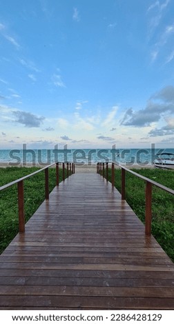 Deck towards the beach in Maragogi, Alagoas. Royalty-Free Stock Photo #2286428129