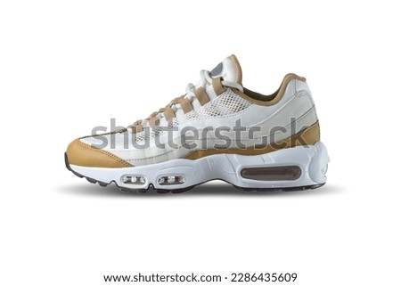 White sneaker with beige, brown accent color on a isolated white background 
