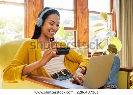 Woman, laptop and credit card with ecommerce and headphones to listen to music while online shopping. Happy female relax at home, podcast or radio streaming with fintech, internet banking and payment