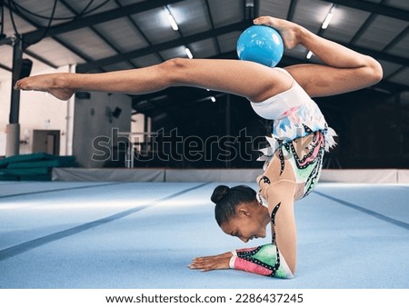 Woman, gymnastics and ball for flexible performance, body balance and dancer in sports arena. Female, rhythmic movement and dancing upside down for creative talent, solo concert and agility challenge