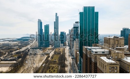 aerial footage captures skyline of downtown Chicago from a bird's-eye view. The sprawling cityscape and towering skyscrapers are full of grandeur energy related to architecture, tourism and cityscapes Royalty-Free Stock Photo #2286437727
