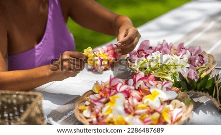 Woman making Hawaiian Lei and Hahu. Process of Handmade flower crown made from Hawaii flower Plumeria. Royalty-Free Stock Photo #2286487689
