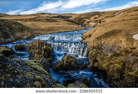 River waterfall in a mountain valley. River valley in mountains. River stream in hill valley. Mountain valley river landscape Royalty-Free Stock Photo #2286505515