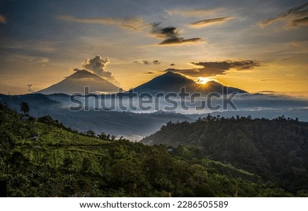 Sunrise over a mountain peak in the early foggy morning. Mountain sunrise landscape. Sunrise in mountains. Beautiful mountain sunrise landscape Royalty-Free Stock Photo #2286505589