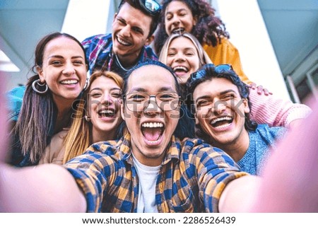 Happy group of multiracial friends taking selfie shot outside on holiday- Young people taking photo looking at camera and having fun- Youth diversity and community concept with guys

