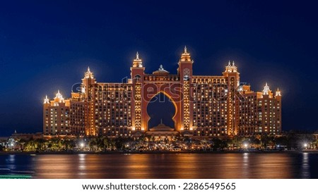 Experience the magic of Dubai's Atlantis hotel at night with our stunning landscape photograph. The iconic hotel, located on the man-made island of Palm Jumeirah Royalty-Free Stock Photo #2286549565