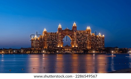 Experience the magic of Dubai's Atlantis hotel at night with our stunning landscape photograph. The iconic hotel, located on the man-made island of Palm Jumeirah Royalty-Free Stock Photo #2286549567