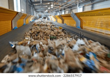 Transportation of fuel obtained from waste (RDF) on a belt to the boiler for combustion. Processing of municipal solid waste into an energy source. Utilization  waste-to-energy.  Royalty-Free Stock Photo #2286557917