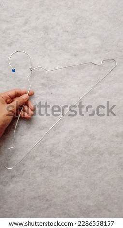 Hands holding a clothes hanger