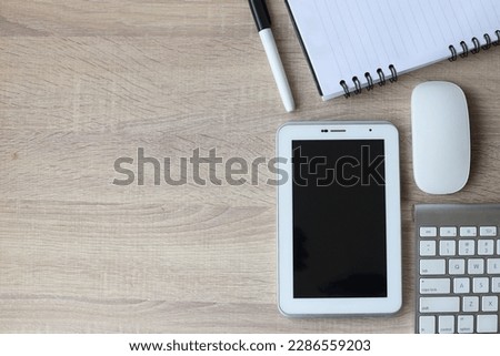 Creative office desk devices, mouse, and keyboard. Landscape top view copy space. Wooden background.