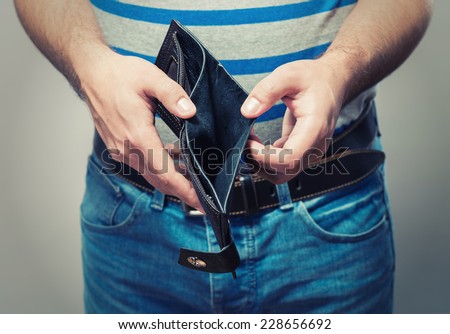 Bankruptcy - Business Person holding an empty wallet Royalty-Free Stock Photo #228656692