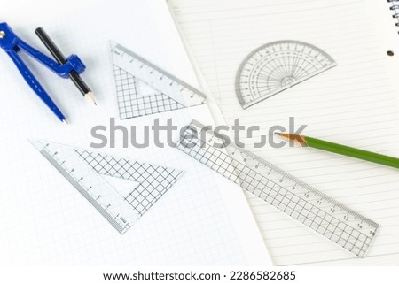 A ruler, notebook and graph paper. image of mathematics