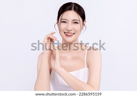 Close up beautiful young Asian woman with clean fresh skin, on white background, facial care, facial treatment. Cosmetology, beauty and spa.