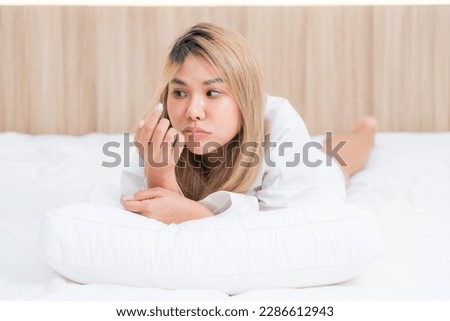cute asian girl funny on bed with pillow