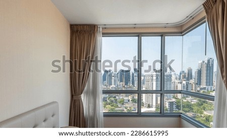 Big window in the bedroom overlooks the skyscrapers.