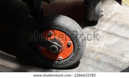 Bolted wheels on a cart partially exposed to direct sunlight