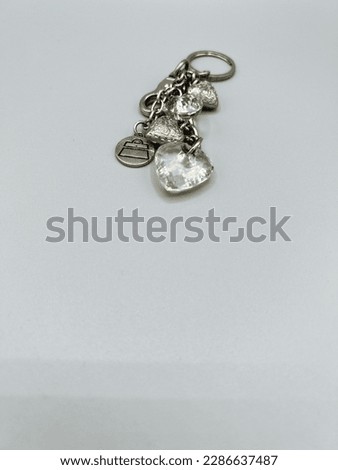 Gray key chain with clear hearts. Fashion accessory.