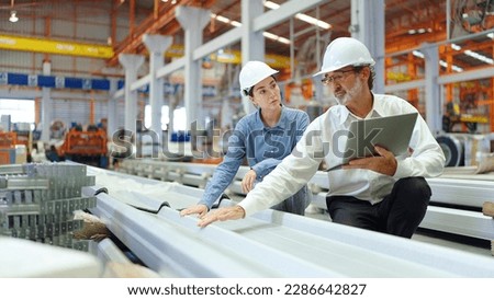 Two engineer manager leader and woman assistant discussing and explaining detail holding laptop talking and checking production of metal sheet roof at metal factory. Recruitment concept