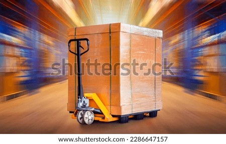 Package Boxes with Hand Pallet Truck in Blurred Warehouse Space. Forklift Loader. Storage Warehouse. Supply Chain Supplies Shipment Goods. Distribution Shipping Warehouse Logistics Royalty-Free Stock Photo #2286647157