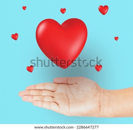 Hand with heart shape isolated on light blue background