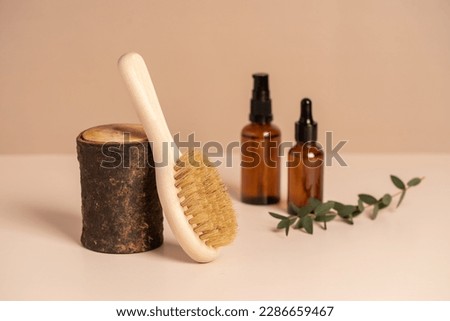 Massage brushes, natural cosmetic in glass bottle and towel. Eco-friendly items. Oral care. Biodegradable personal care products.