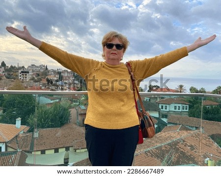 Senior adventure is ageless woman with backpack walking on old city of Antalya Turkey. Summer active tourism for pensioner. Outdoors
