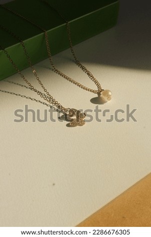 two beautiful necklaces in the sun