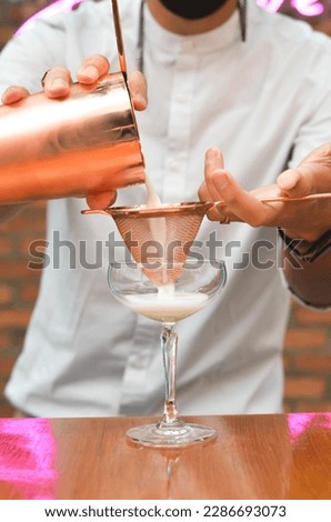 Bartender Finishing A Martini Cocktail 