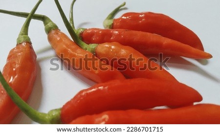 fresh red and orange chilies with green stalks