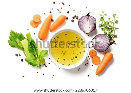 Chicken broth, stock or bouillon with vegetables isolated on white background. top view