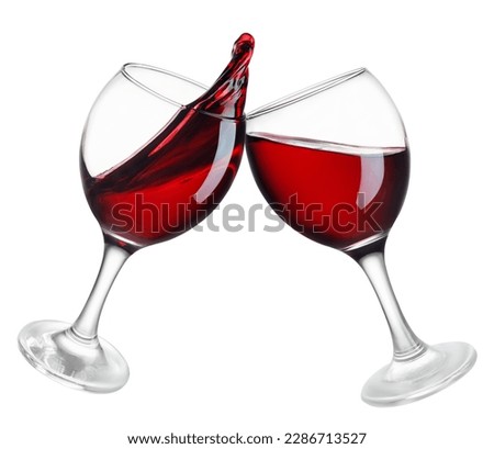 two glasses of red wine in toasting gesture with splash isolated on white background Royalty-Free Stock Photo #2286713527