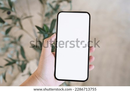 Women's hands holding cell telephone blank copy space screen. smartphone with blank white screen isolated. smart phone with technology concept