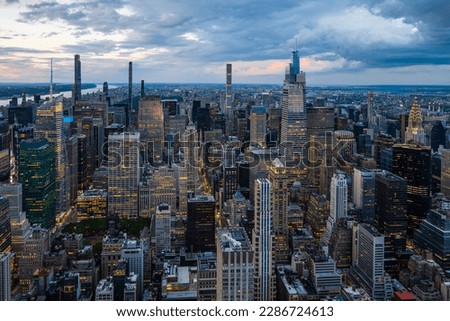 An illuminated midtown of New York City and rainy clouds above. Royalty-Free Stock Photo #2286724613