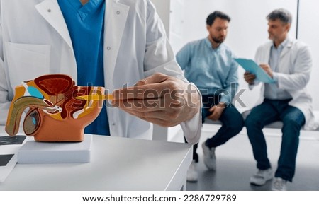 Prostate cancer treatment. Doctor consulting male patient with suspected prostate cancer while visit in urology center Royalty-Free Stock Photo #2286729789