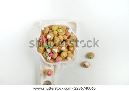 Selective focus of Kue Kancing or small biscuits with colorful sugar topping.