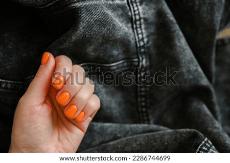 Women's hands with the colorful pattern on the nails.