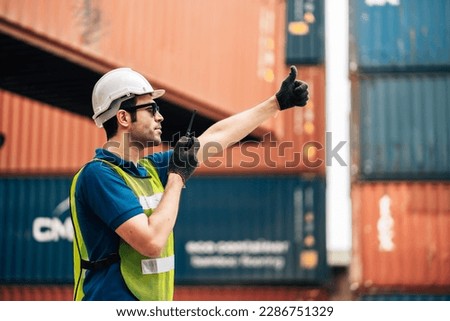 Logistics, shipping and construction worker man using walkie talkie in shipyard. Transportation engineer on smartphone in delivery, freight and international distribution business in container yard Royalty-Free Stock Photo #2286751329