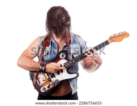 Excited guitarist in jeans jacket, isolated on white background.
Man with hidden face from own flying hair play at electric guitar.