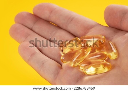 closeup hand holding fish oil vitamin for healthy. Royalty-Free Stock Photo #2286783469