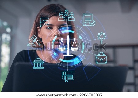 Pensive attractive beautiful businesswoman in formal wear working on laptop at office workplace in background. flying legal icons. Concept of law and order.
