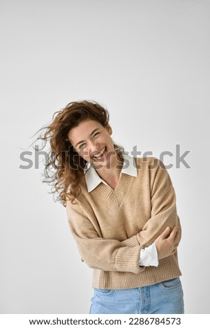 Young funny smiling charming sincere positive woman, happy joyful cheerful cute curly girl student laughing having fun standing isolated at white background, vertical authentic candid shot. Royalty-Free Stock Photo #2286784573