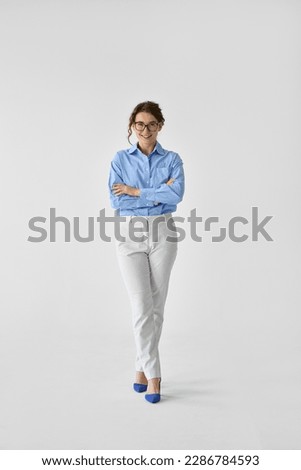 Happy young smiling confident professional business woman, happy stylish pretty lady executive looking at camera, standing isolated at white background, vertical full length portrait.