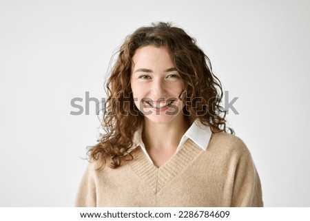 Young smiling positive woman, happy curly joyful cheerful girl student laughing, looking at camera standing isolated at white background, advertising products and services, close up headshot portrait. Royalty-Free Stock Photo #2286784609