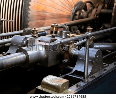 Close up of land based steam engine moving parts made of steel