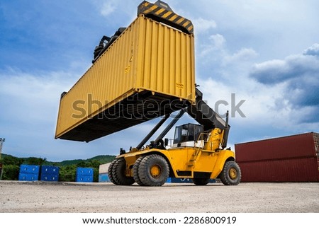 forklift Truck working in the container cargo yard port loading cargo tank logistics service and transportation concept. Royalty-Free Stock Photo #2286800919