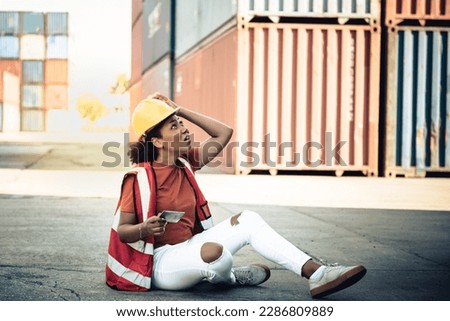 African American female worker, accident during work, with objects falling on the head where she was wearing a helmet. to worker industry and work accident concept.