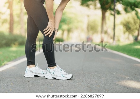 adult woman with muscle pain during running. runner have knee ache due to Runners Knee or Patellofemoral Pain Syndrome, osteoarthritis and Patellar Tendinitis. Sports injuries and medical concept Royalty-Free Stock Photo #2286827899