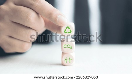 Sustainable energy and technology concept, energy, futuristic business, businessman putting wooden blocks and energy icons