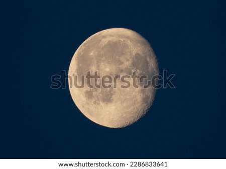 The waning gibbous moon hangs high in the sky, its golden glow casting a serene and peaceful aura over the world below. As the moon slowly makes its way towards its next phase.